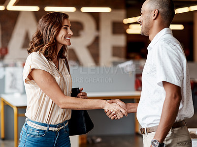Buy stock photo Shot of a young businesswoman shaking hands with a colleague during a meeting in a modern office