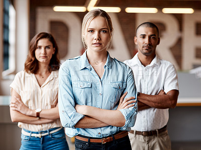 Buy stock photo Portrait of a group of confident young businesspeople working together in a modern office