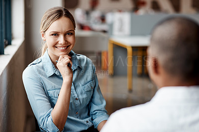 Buy stock photo Shot of a young businesswoman having a discussion with a colleague in a modern office