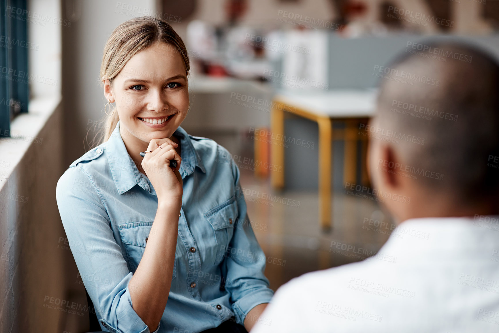 Buy stock photo Shot of a young businesswoman having a discussion with a colleague in a modern office