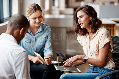 Buy stock photo Shot of a group of young businesspeople having a meeting in a modern office