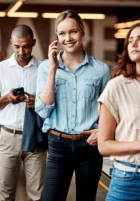 Buy stock photo Shot of a young businesswoman using a smartphone while waiting in line in a modern office