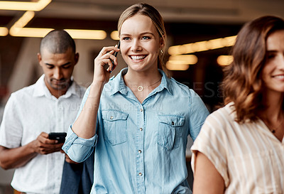 Buy stock photo Shot of a young businesswoman using a smartphone while waiting in line in a modern office