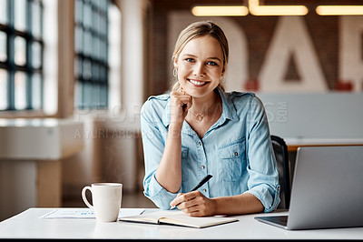 Buy stock photo Shot of a young businesswoman using a laptop in a modern office.