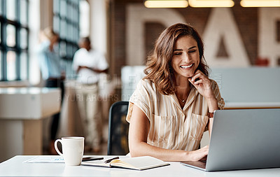 Buy stock photo Shot of a young businesswoman using a laptop in a modern office