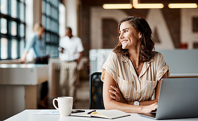 Buy stock photo Shot of a young businesswoman using a laptop in a modern office