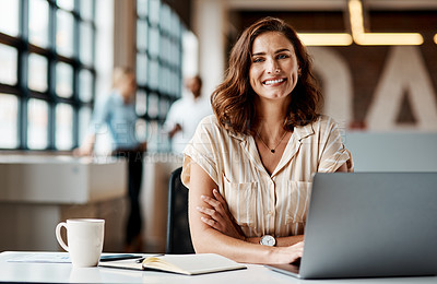 Buy stock photo Shot of a young businesswoman using a laptop in a modern office