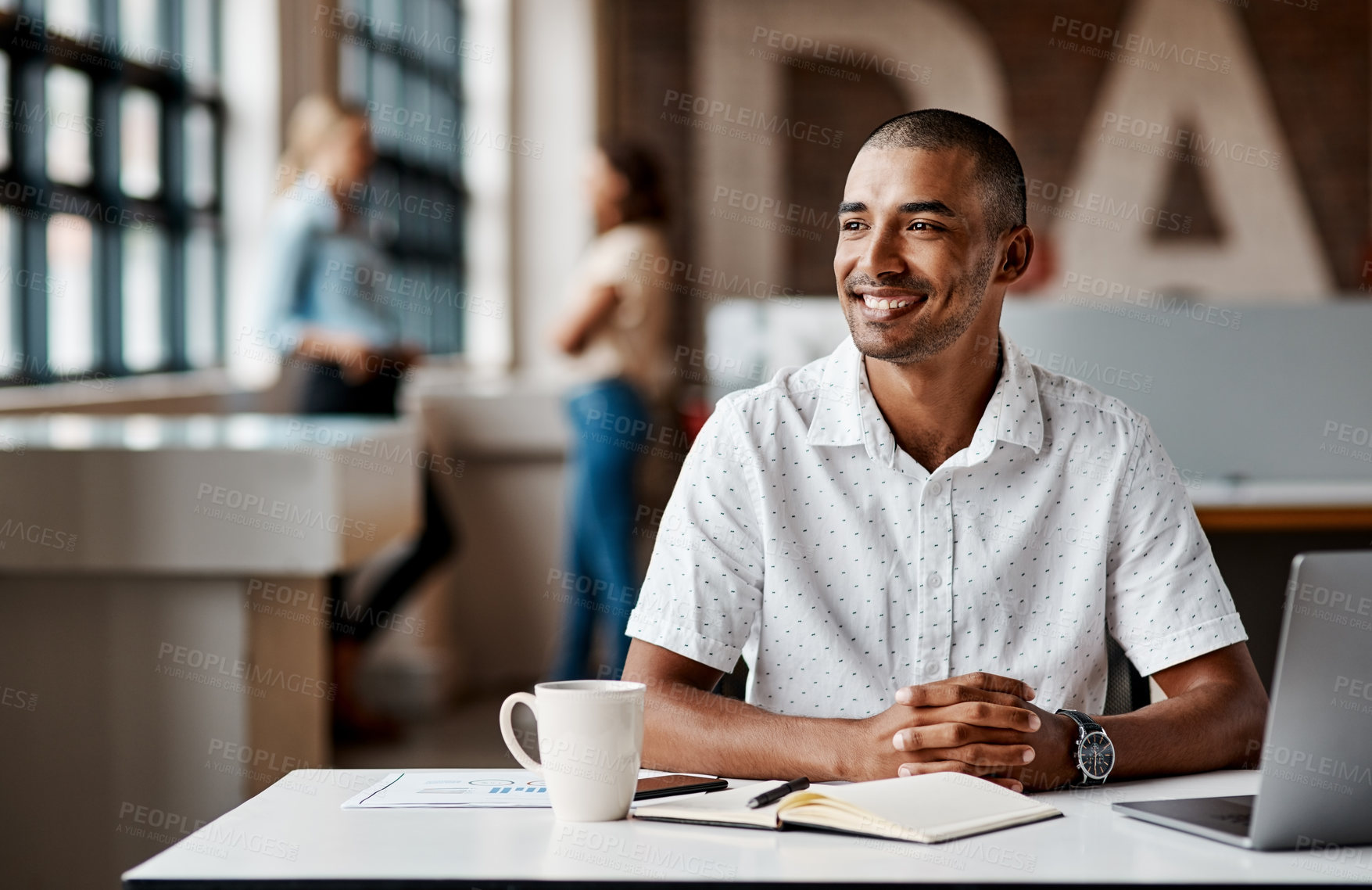 Buy stock photo Shot of a young businessman using a laptop in a modern office