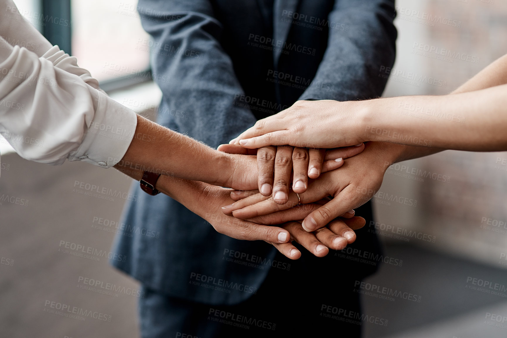 Buy stock photo Closeup shot of a group of unrecognisable businesspeople joining their hands together in a huddle
