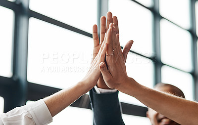 Buy stock photo Closeup shot of a group of unrecognisable businesspeople giving each other a high five in an office
