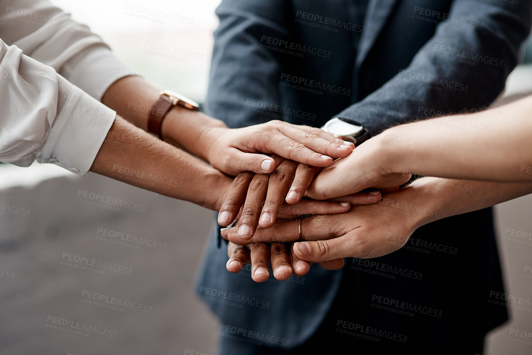 Buy stock photo Closeup shot of a group of unrecognisable businesspeople joining their hands together in a huddle