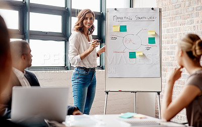 Buy stock photo Shot of a young businesswoman giving a presentation to her colleagues in an office