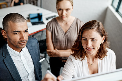 Buy stock photo High angle shot of a group of businesspeople brainstorming together on a whiteboard in an office