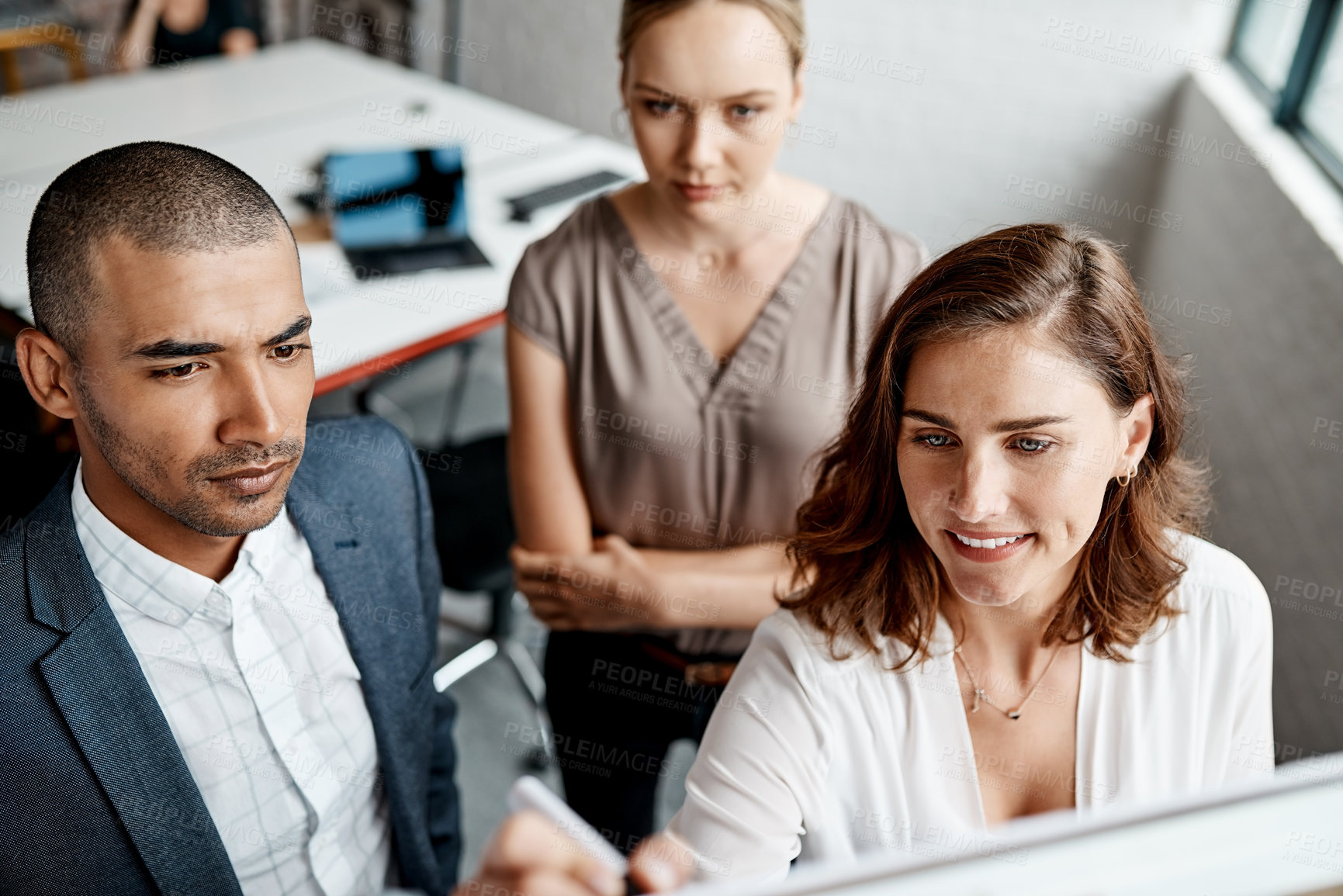 Buy stock photo High angle shot of a group of businesspeople brainstorming together on a whiteboard in an office