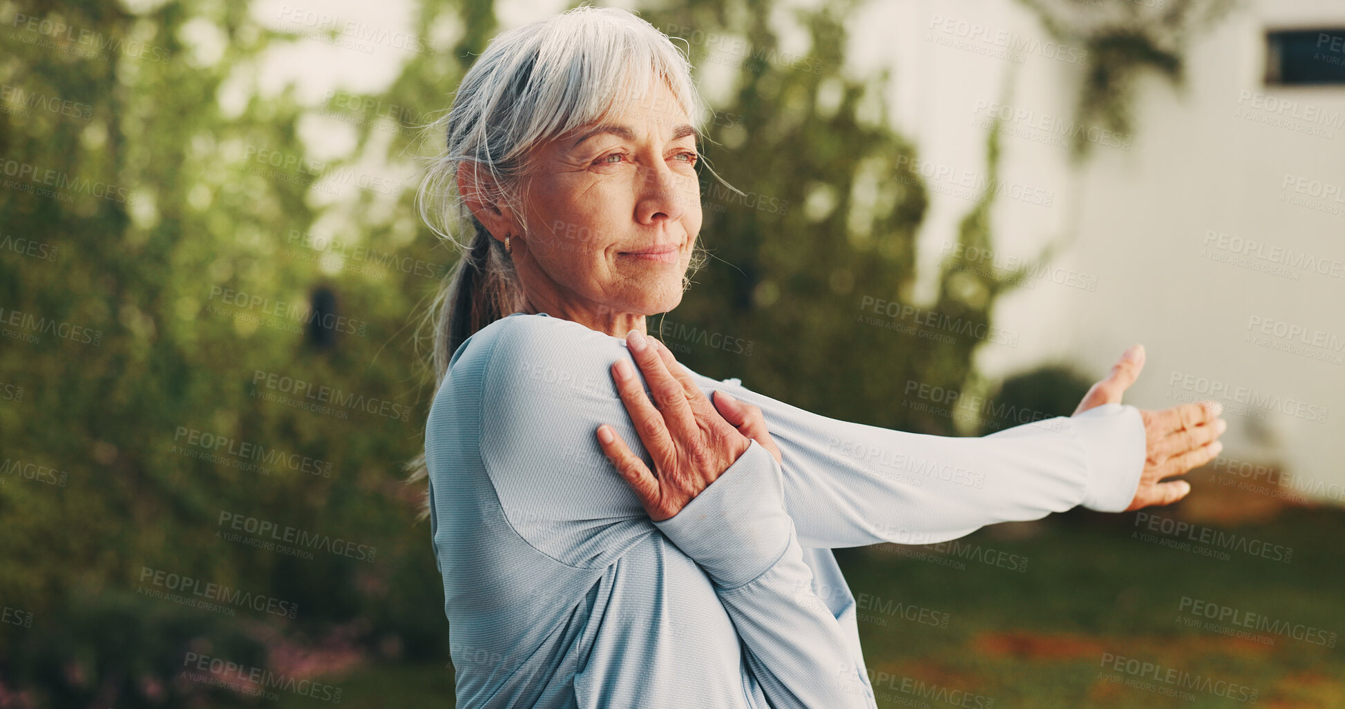 Buy stock photo Backyard, wellness and senior woman stretching for functional fitness, shoulder mobility or exercise. Active, pensioner or arm warm up at house for retirement health, physical activity or flexibility