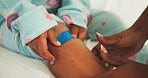 Mother, hands and child with bandage for knee injury, first aid assistance and healing wound in home. Woman, daughter and help in house with plaster application, bruise and hurt leg from accident.