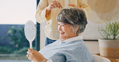 Buy stock photo Haircare, elderly mother or woman in house with mirror, grooming or family bonding in morning routine. Happy, senior mom or daughter with comb, getting ready or hair styling assistance in retirement.