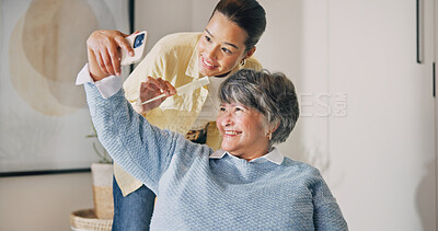 Buy stock photo Happy, senior mother and selfie with woman in house, profile picture or grooming with comb in lounge. Family, connection and old person with smile for memory, photography and styling hair in home