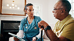 Nurse, tablet and senior man in house for medical diagnosis, checkup or healthcare visit. Woman, caregiver or health worker talking to patient with technology or cane for elderly care in nursing home
