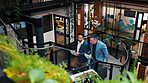 Above, manager and man with tablet on steps for financial forecasting with market research in office. Economist, advice and collaboration for business strategy, chat and people with tech on stairs