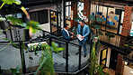 Above, manager and man with tablet on stairs for financial forecasting with market research in office. Economist, advice and collaboration for business strategy, chat and people with tech on steps