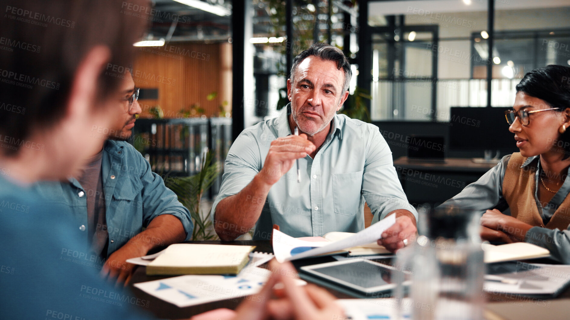 Buy stock photo Man, speaking and meeting in office with data analysis, proposal and forecast for revenue growth. Manager, people and discussion in business with graphs, finance stats or advice for income projection