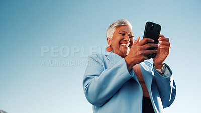 Buy stock photo Laughing, online and woman with phone, outdoor and planning for campaign or brand awareness on web. Digital marketing, social media manager or mature person with tech for info, low angle or sky space