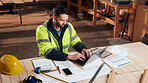 Documents, laptop and man in workshop for construction contract, material supplier and carpentry. Paperwork, computer and person with inventory report, timber order and planning for wood production