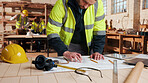 Carpentry, man and blueprint review in workshop for shopfitting, custom furniture design and staff. Tech, carpenter and floor plan in warehouse for woodwork project, cabinetry layout and evaluation