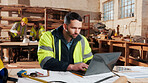 Reading, laptop and man in workshop for construction contract, material supplier and carpentry. Contractor, research and person on computer with inventory, timber stock or planning for infrastructure