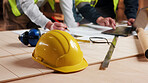 Helmet, hands and meeting with laptop in carpentry for shopfitting project, design review and ppe. Carpenter team, tech and people with blueprint in workshop for custom furniture, planning or hardhat