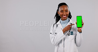 Buy stock photo Green screen, phone and portrait of doctor in studio for medical service, health app and mockup. Pointing, space and black woman on cellphone for news, healthcare and telehealth on white background