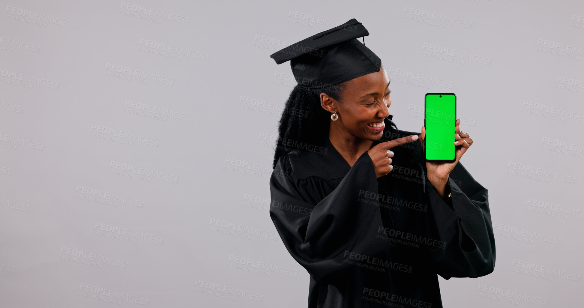 Buy stock photo Student, phone and black woman with green screen for graduation app on a white background. Female person, graduate or pointing with smile, technology display or UI for qualification on mockup space