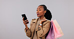 Shock, phone or black woman with shopping bags in studio for missed promotion on a white background. Upset, female person or shopper with smartphone or gift for payment notification or bad price app