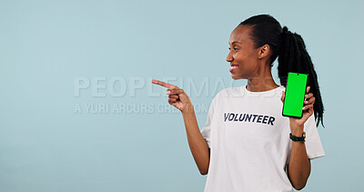 Buy stock photo Volunteer, phone and black woman with green screen for donation app on a white background. Female person, helper or pointing with smile, technology display or UI for charity campaign on mockup space