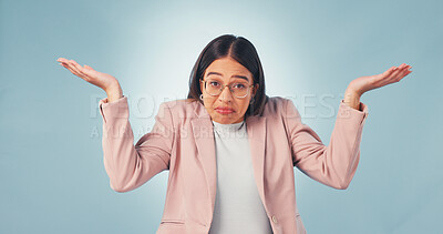 Buy stock photo Confused, woman and shrug in studio for business choice, decision or blue background. Doubt, portrait and female person with dont know gesture with question, unsure or puzzled with options comparison