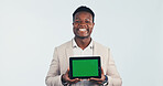 Portrait, tablet and black man with green screen in studio for business advertising on a white background. Happy, businessman and smile with technology display for marketing app on mockup space