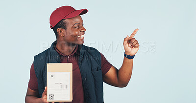 Buy stock photo Pointing, box and delivery man in studio for shipping news, advertising and ecommerce info. Mockup, happy and African person with gesture for logistics, courier service and space on blue background