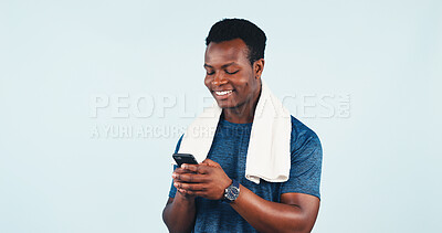 Buy stock photo Fitness, phone or towel with black man in studio for health tracking or progress report. App, smile and space with happy person typing on mobile for exercise feedback, message or review on background