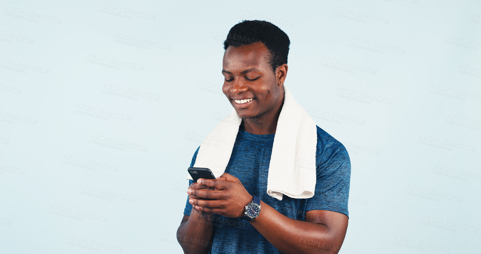 Buy stock photo Fitness, phone or towel with black man in studio for health tracking or progress report. App, smile and space with happy person typing on mobile for exercise feedback, message or review on background