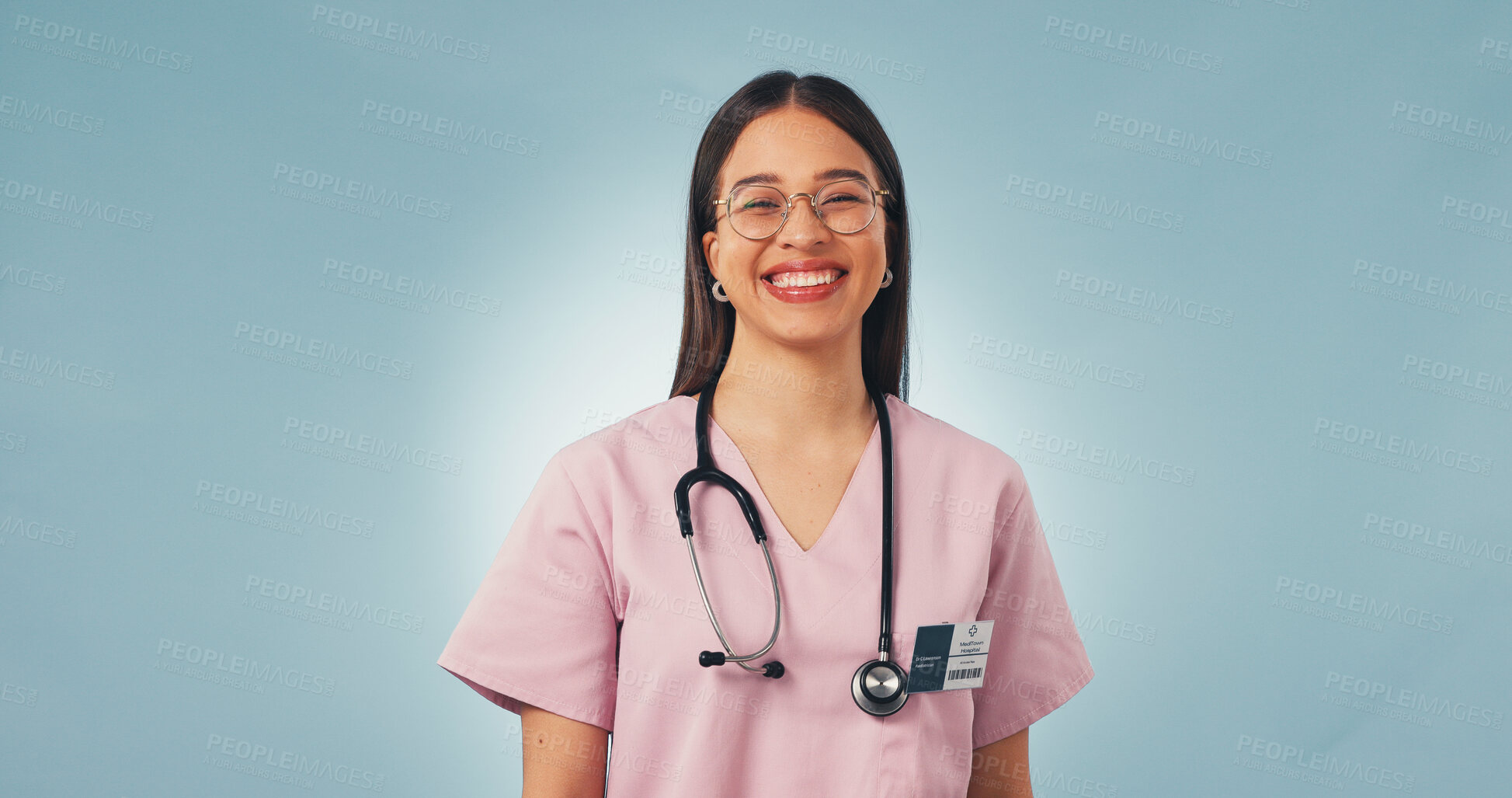 Buy stock photo Portrait, woman and nurse in studio for healthcare, wellness and cancer care on blue background space. Happy female person, medical worker and oncology professional with confidence, pride or about us