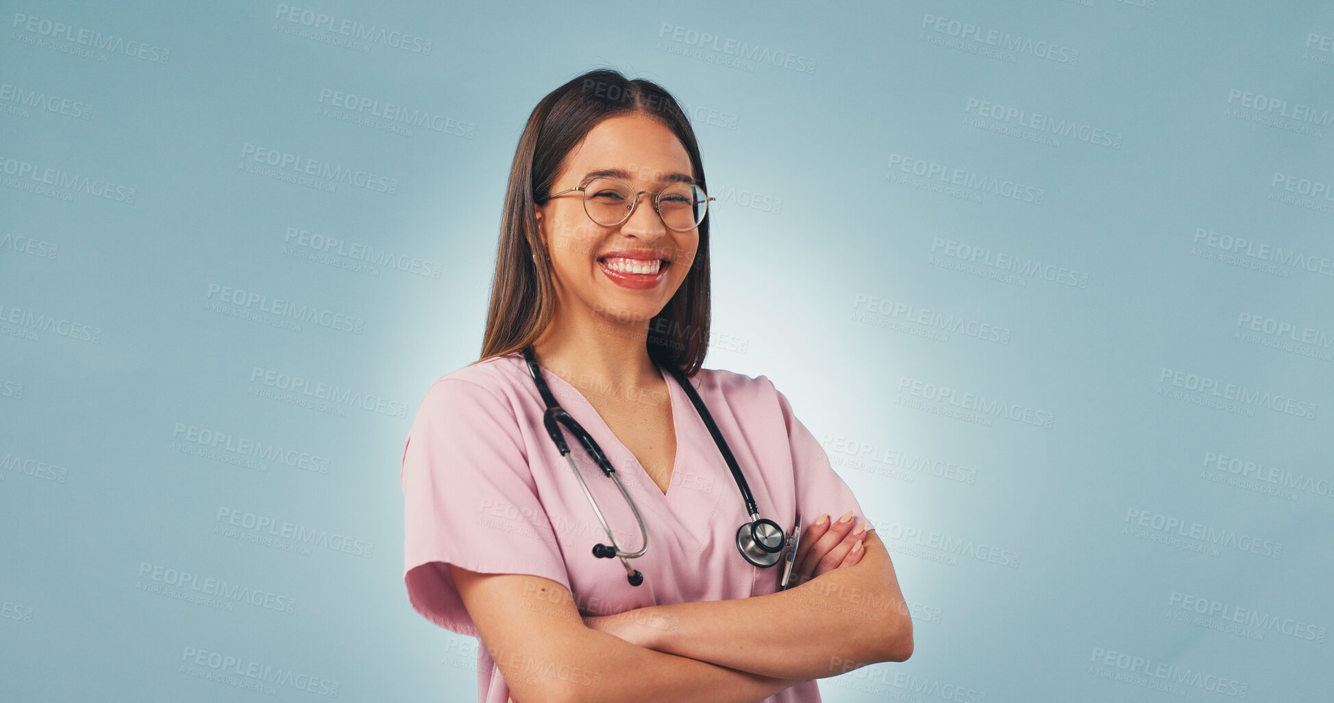 Buy stock photo Arms folded, woman or nurse in studio for healthcare, portrait or cancer care on blue background space. Happy female person, medical worker or oncology professional with confidence, pride or about us