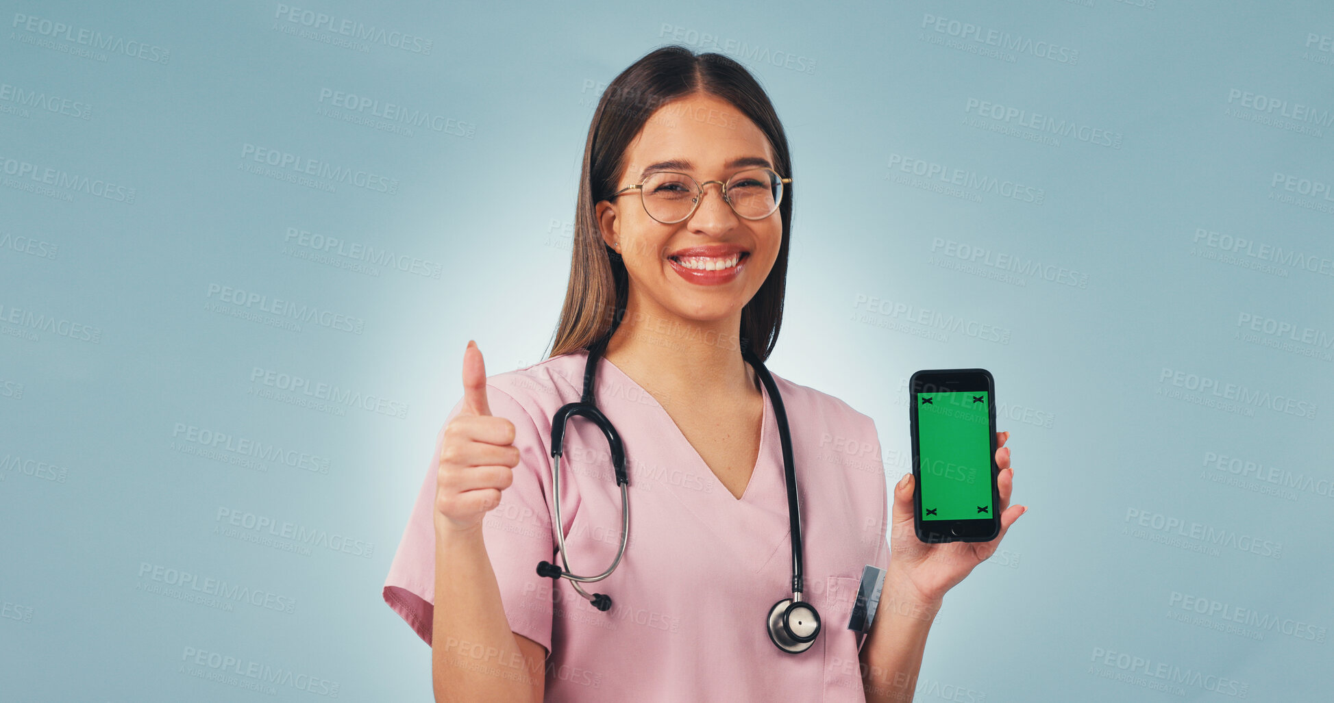Buy stock photo Nurse, portrait and happy woman with phone green screen for advertising on a blue studio background. Female person, healthcare worker or smile with smartphone display or like emoji on mockup space