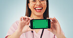 Nurse, portrait and woman with phone green screen for advertising on a blue studio background. Female person, healthcare worker or smile with smartphone display for UI, UX or marketing Telehealth app