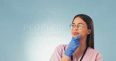 Buy stock photo Nurse, woman and thinking in studio with vision, mockup space or idea for female reproductive health. Medical worker, person and problem solving for gynecology, reflection or plan on blue background.