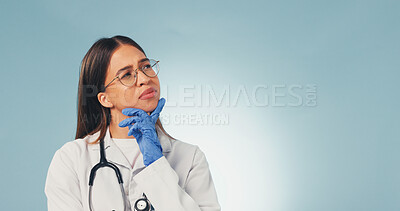 Buy stock photo Confused, woman or doctor thinking in studio with mockup space or plan for difficult medical decision. Healthcare worker, person and doubt for diagnosis, problem solving or concern on blue background