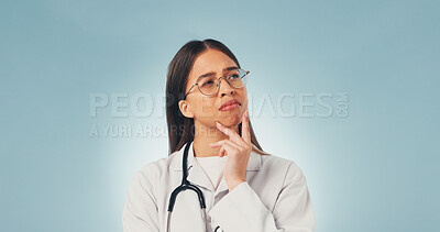 Buy stock photo Thinking, glasses and doctor in studio for planning, ideas or problem solving for medical career. Solution, woman and healthcare worker on blue background with decision, choice or reflection.