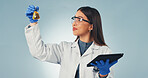 Science, liquid and woman on tablet in studio for chemistry, experiment results or medical research. Pharmaceutical, tech and person with chemical sample, beaker or vaccine report on blue background