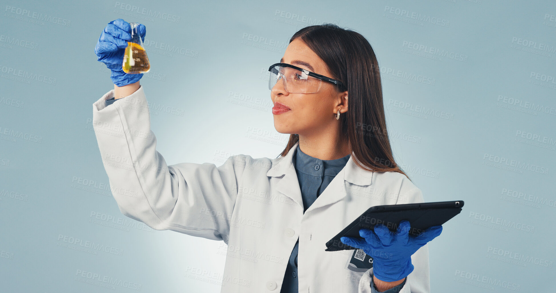 Buy stock photo Science, liquid and woman on tablet in studio for chemistry, experiment results or medical research. Pharmaceutical, tech and person with chemical sample, beaker or vaccine report on blue background