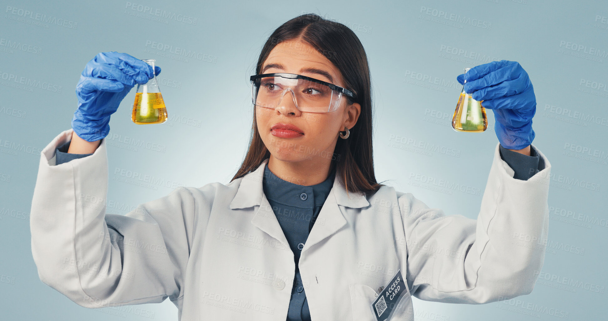 Buy stock photo Science, liquid and woman in studio with decision, options or observation for chemical reaction. Pharmaceutical, thinking and person with sample, vaccine choice or medical research on blue background